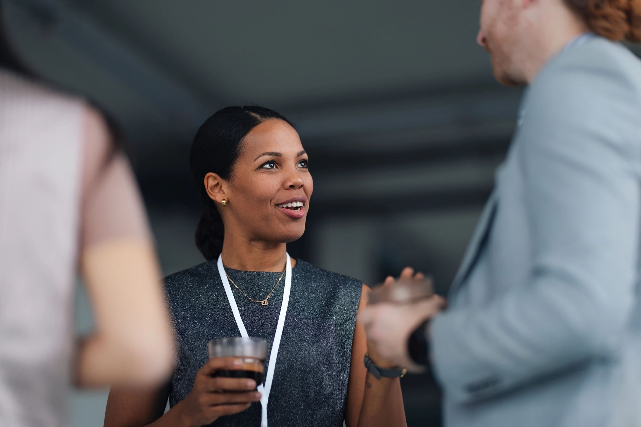 Professional leader speaking with colleagues at a conference